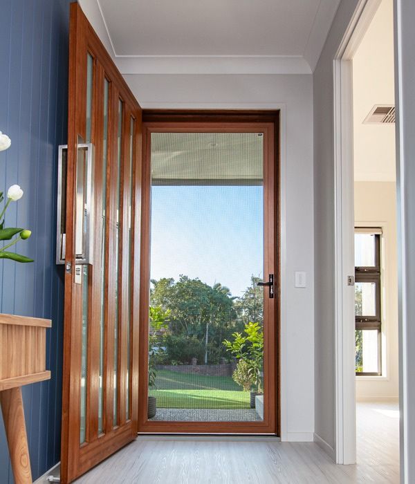 A Hallway With A Wooden Door And A Table — Nambucca Glass In Nambucca Heads, NSW