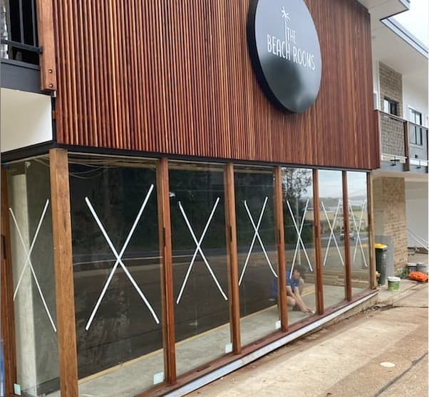 A Building With A Sign That Says The Beach Rooms — Nambucca Glass In Macksville, NSW