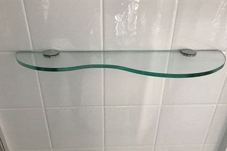 A Glass Shelf Is Hanging On A White Tiled Wall — Nambucca Glass in Nambucca Heads, NSW