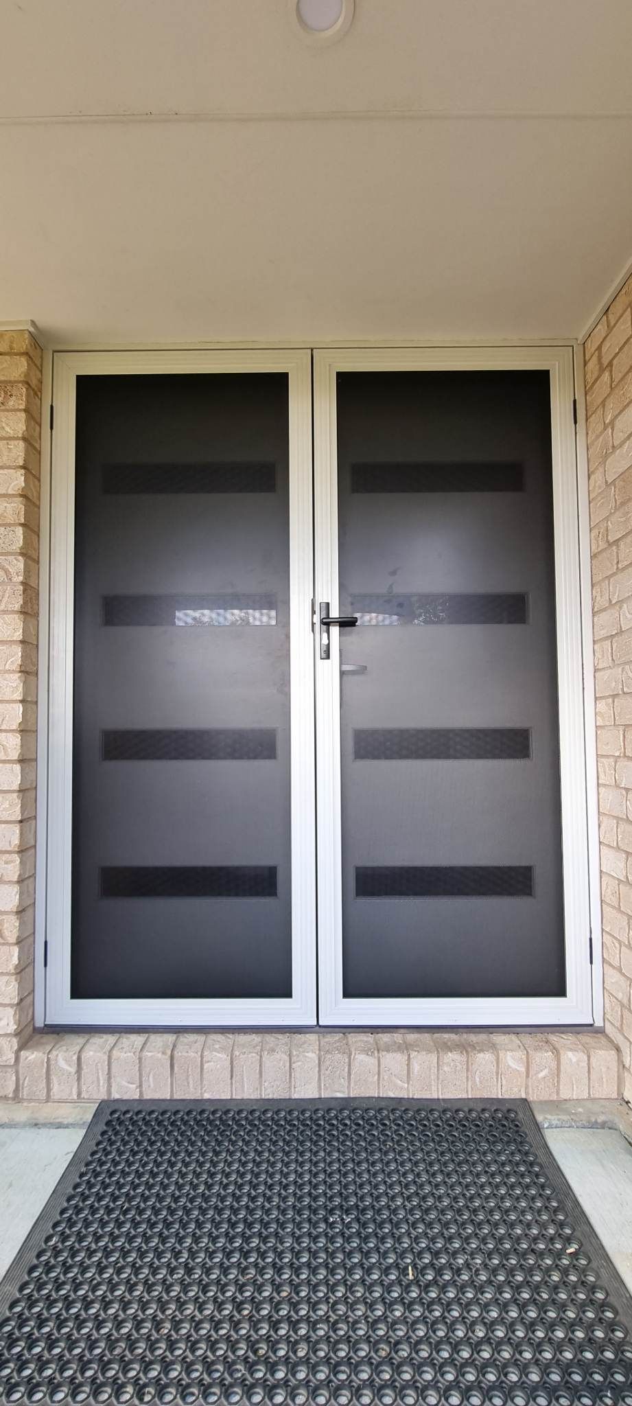 There Is A Door With A Mat In Front Of It — Nambucca Glass in Nambucca Heads, NSW