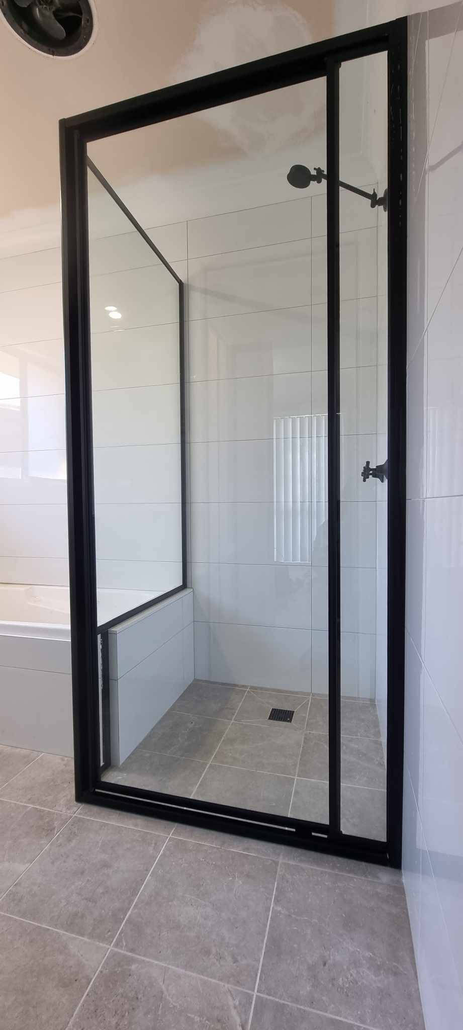 A Bathroom With A Walk In Shower With A Black Frame — Nambucca Glass in Nambucca Heads, NSW
