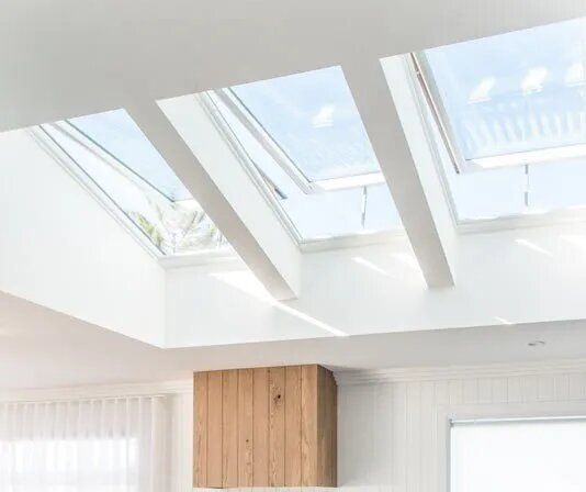 A Living Room With A Skylight And A Wooden Chimney — Nambucca Glass in Nambucca Heads, NSW
