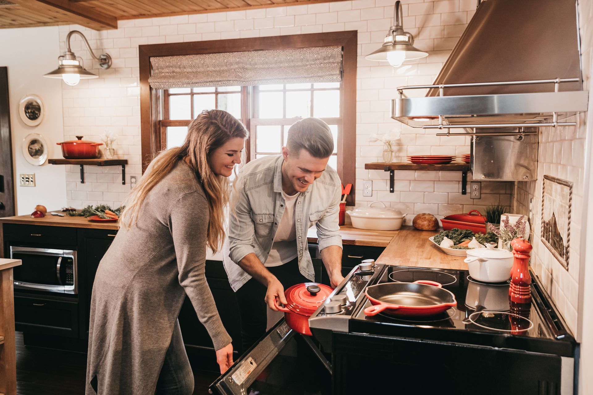 man and woman cooking dinner in a home kitchen