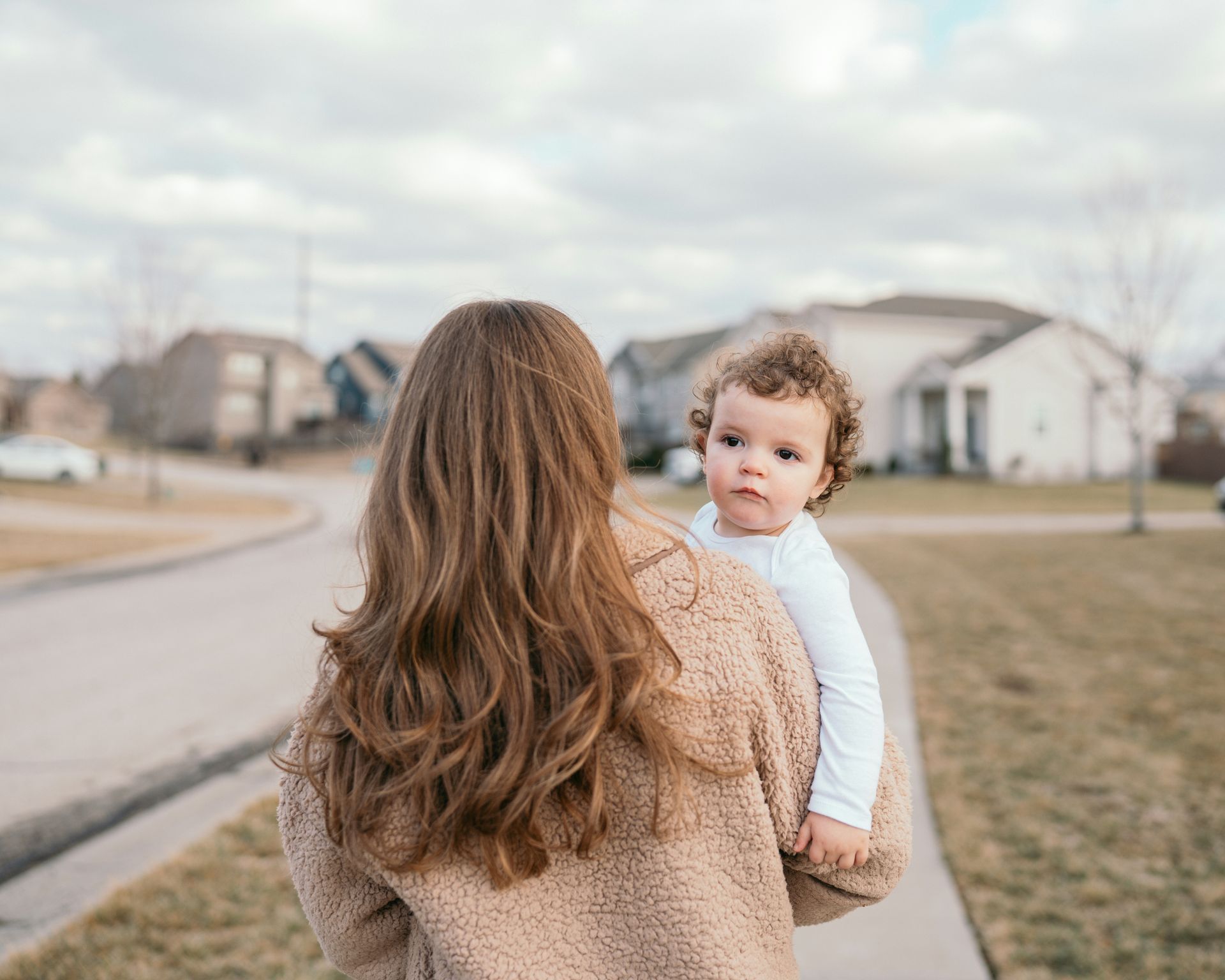 woman holding a baby in a neighborhood