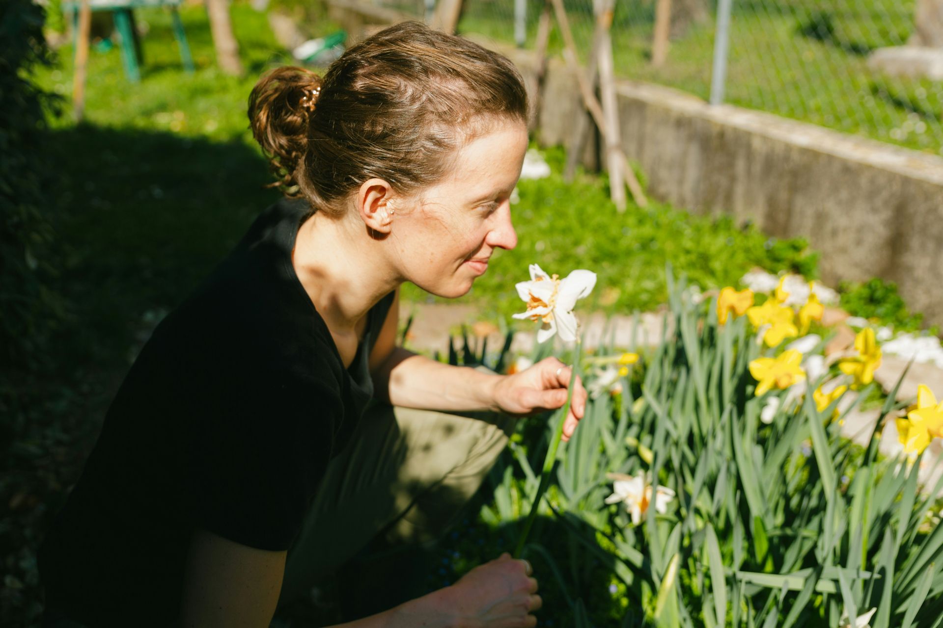 woman in garden picking flowers