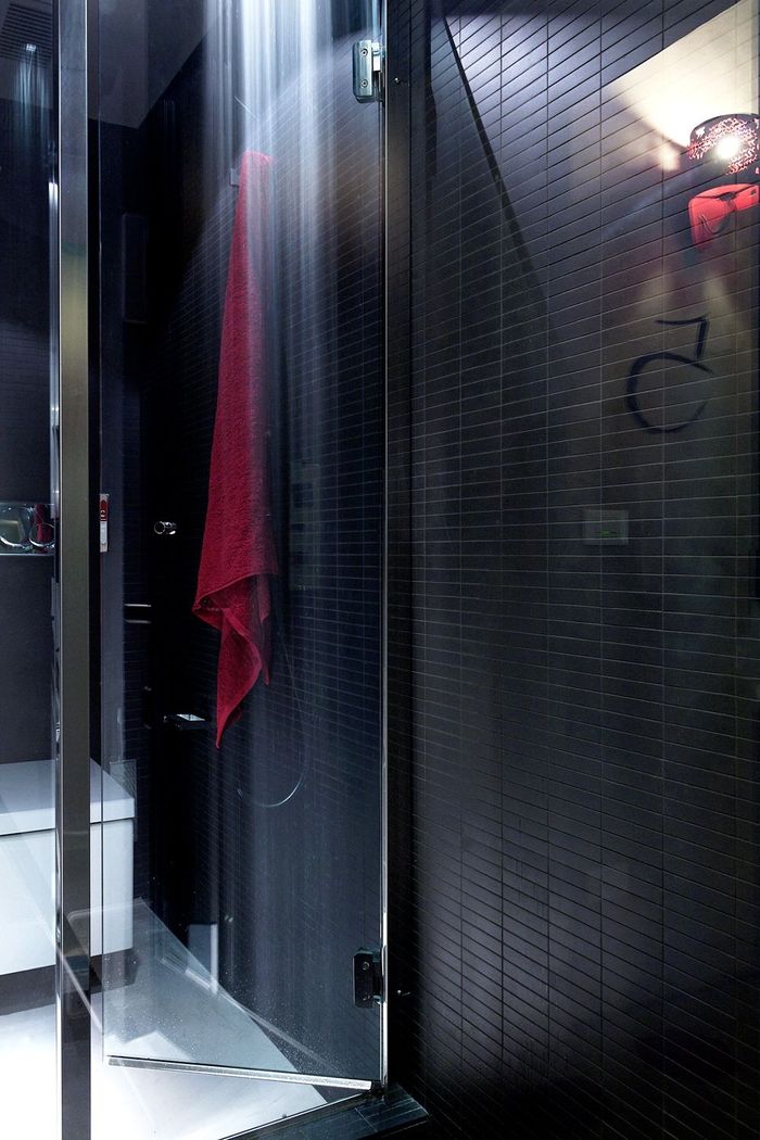 A bathroom with a red towel hanging on the wall