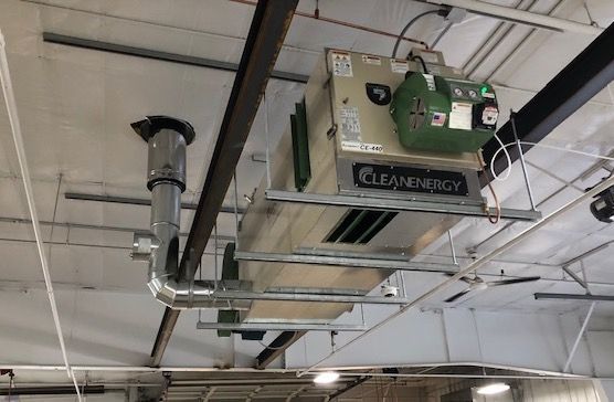 A clean energy heater is hanging from the ceiling of a building.