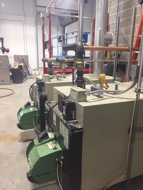 A row of boilers are lined up in a room