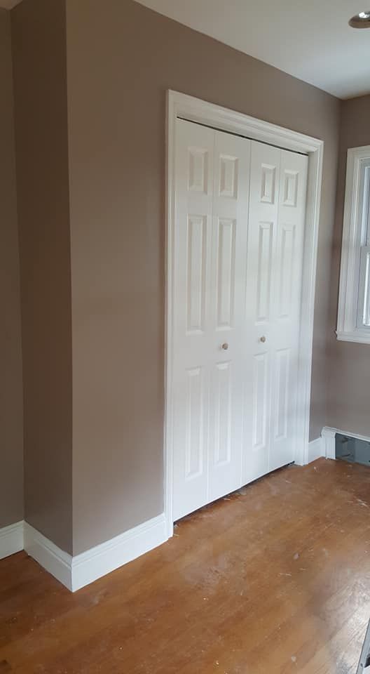 White door of a room and wooden flooring