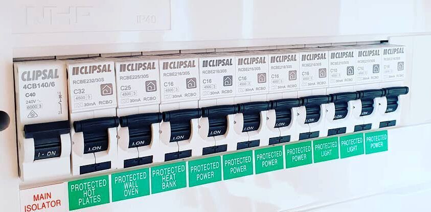 A close up of a row of circuit breakers on a wall.