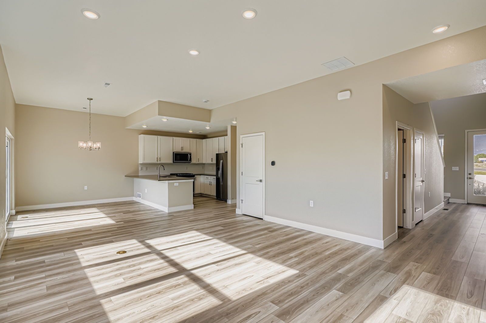 Two-story townhome living room and hallway to entrance