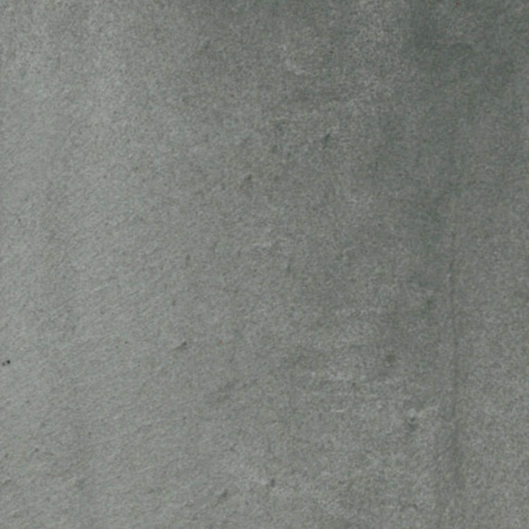 Un gros plan d'une surface grise avec une texture granuleuse