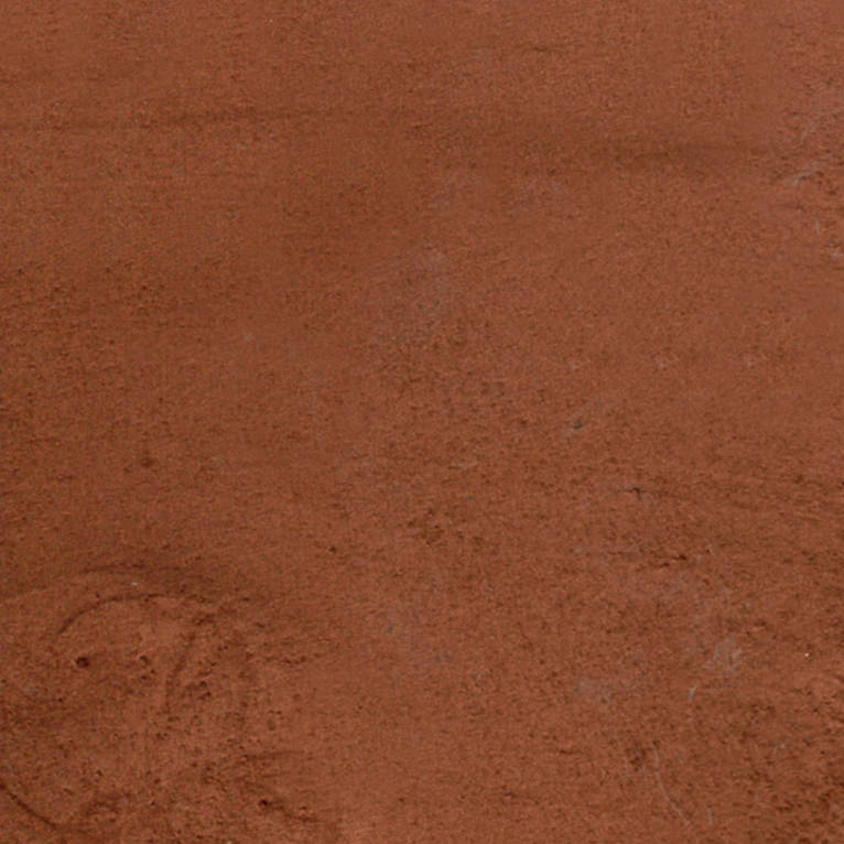 Un gros plan d'une surface brune avec une texture granuleuse.