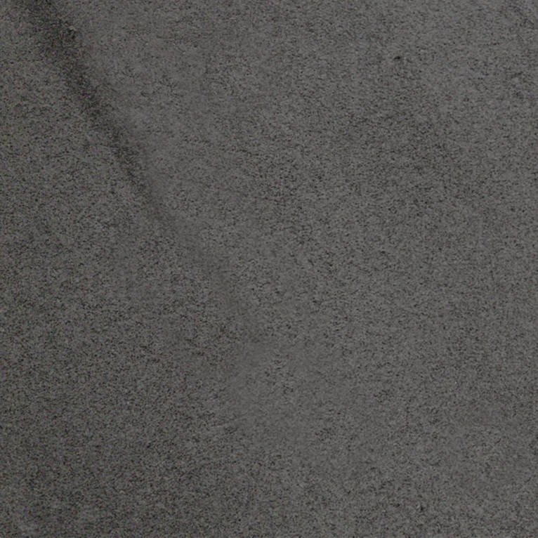 Un gros plan d'une surface grise avec une texture granuleuse.