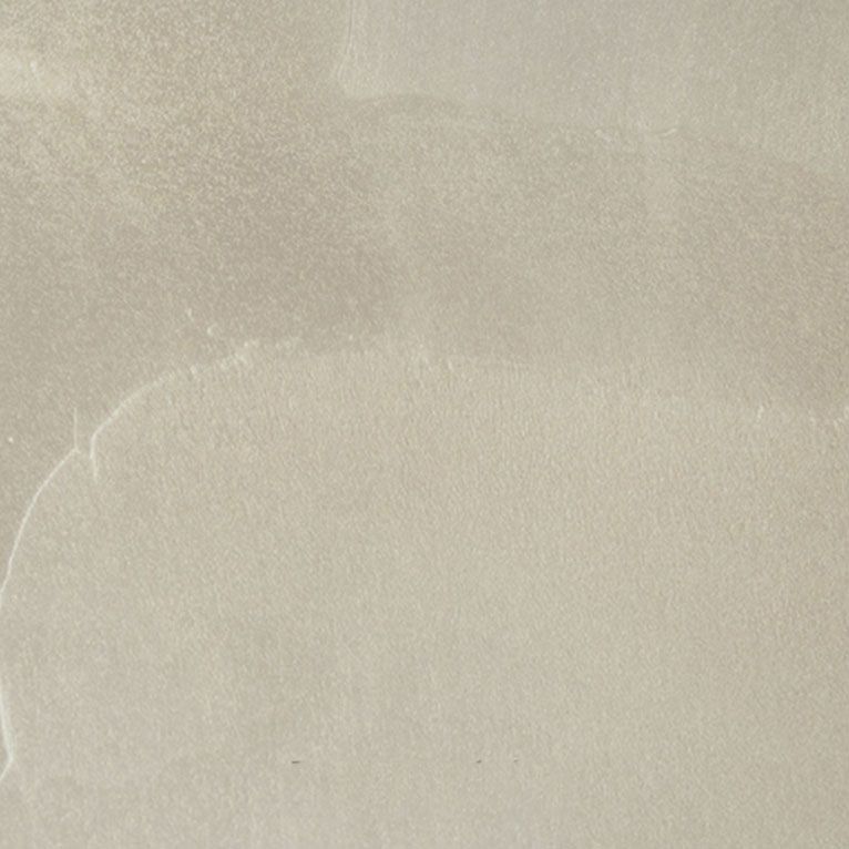 Un gros plan d'un carreau blanc avec une texture de marbre.