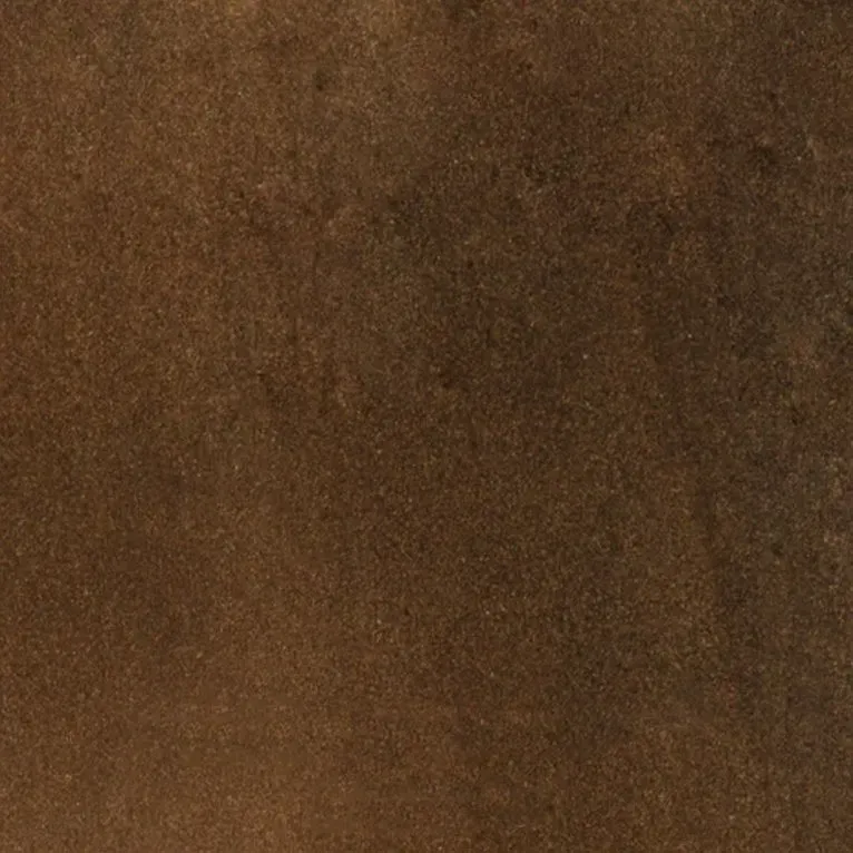 Un gros plan d'une tuile marron avec une texture granuleuse.