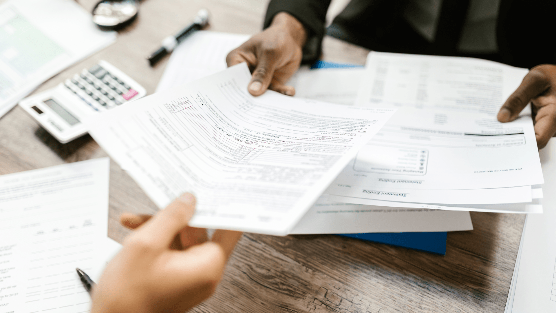 A person is handing a piece of paper to another person.