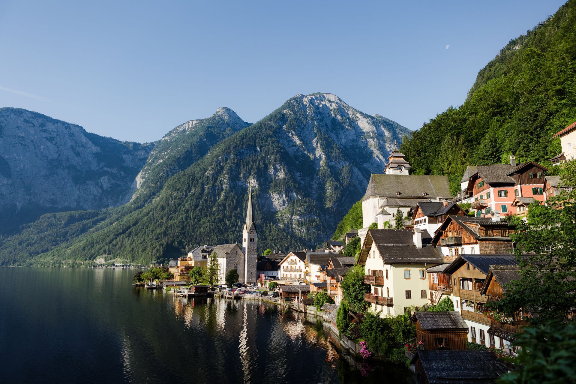 Hallstatt village nestled by a lake, with mountains in the background.