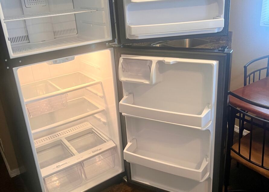 An open black refrigerator showing the interior.