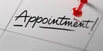 The word appointment is written on a calendar with a red pin.