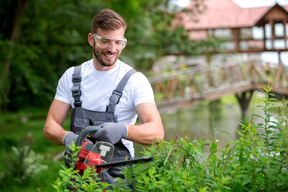 Man Trimming the Shrub  — Putnam Valley, NY — B & B Landscaping & Gardening Inc.