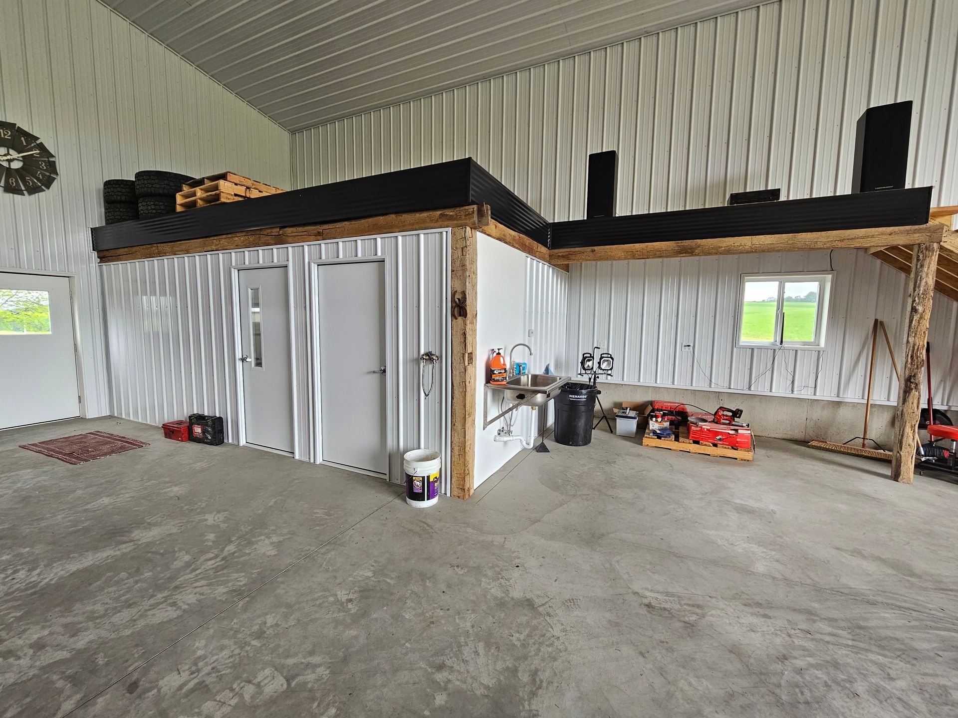 A large empty room with a concrete floor and white walls.