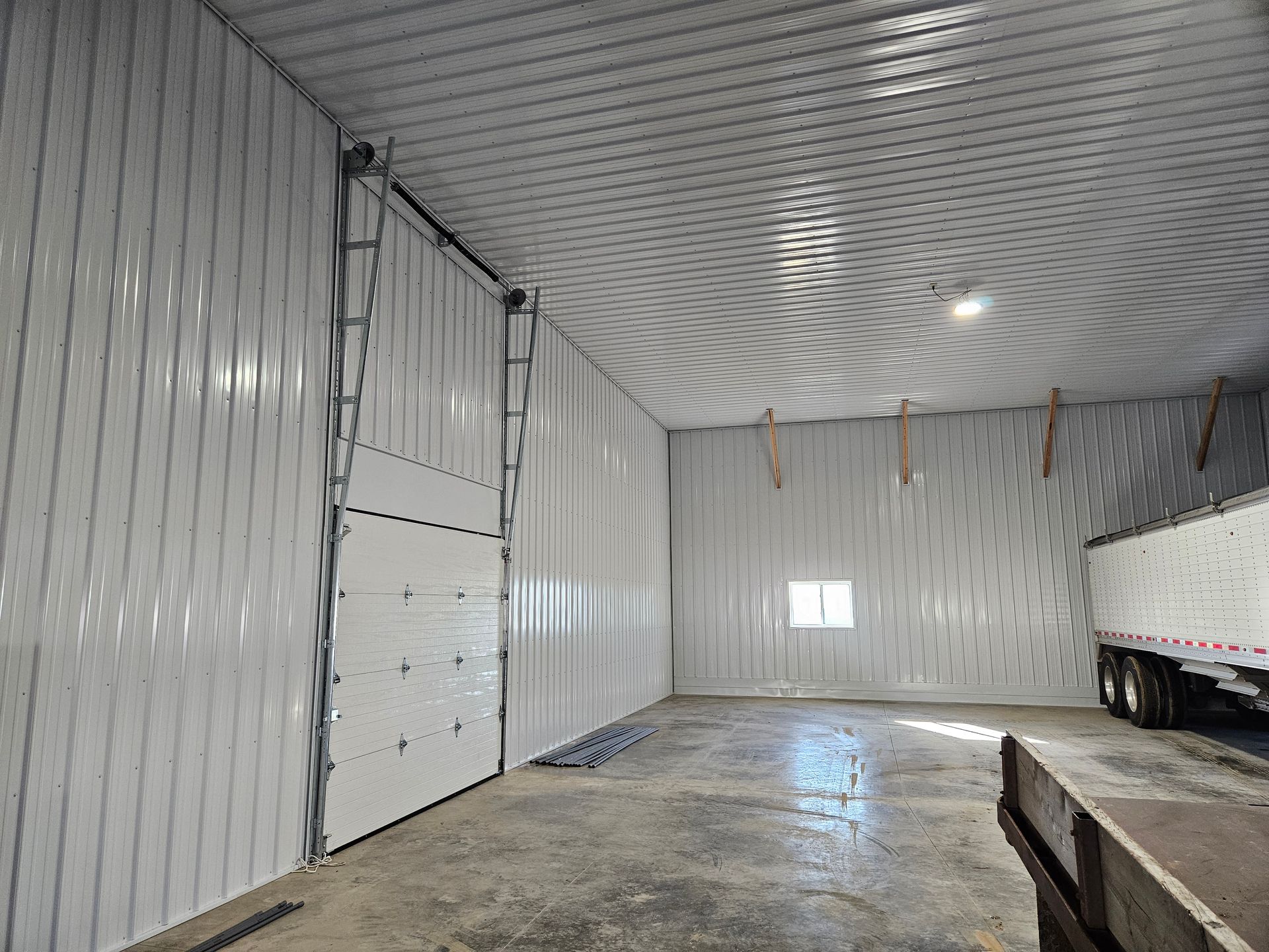 A large warehouse with a truck parked inside of it.