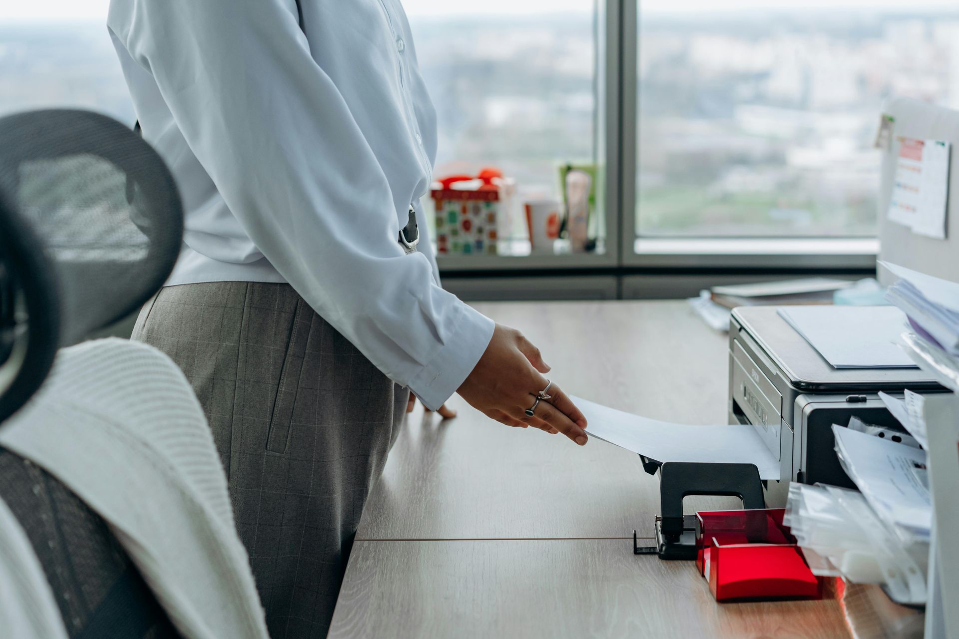 Office worker retrieving a document from a networked printer