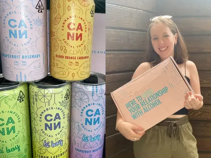 A woman is holding a box next to a stack of cans.