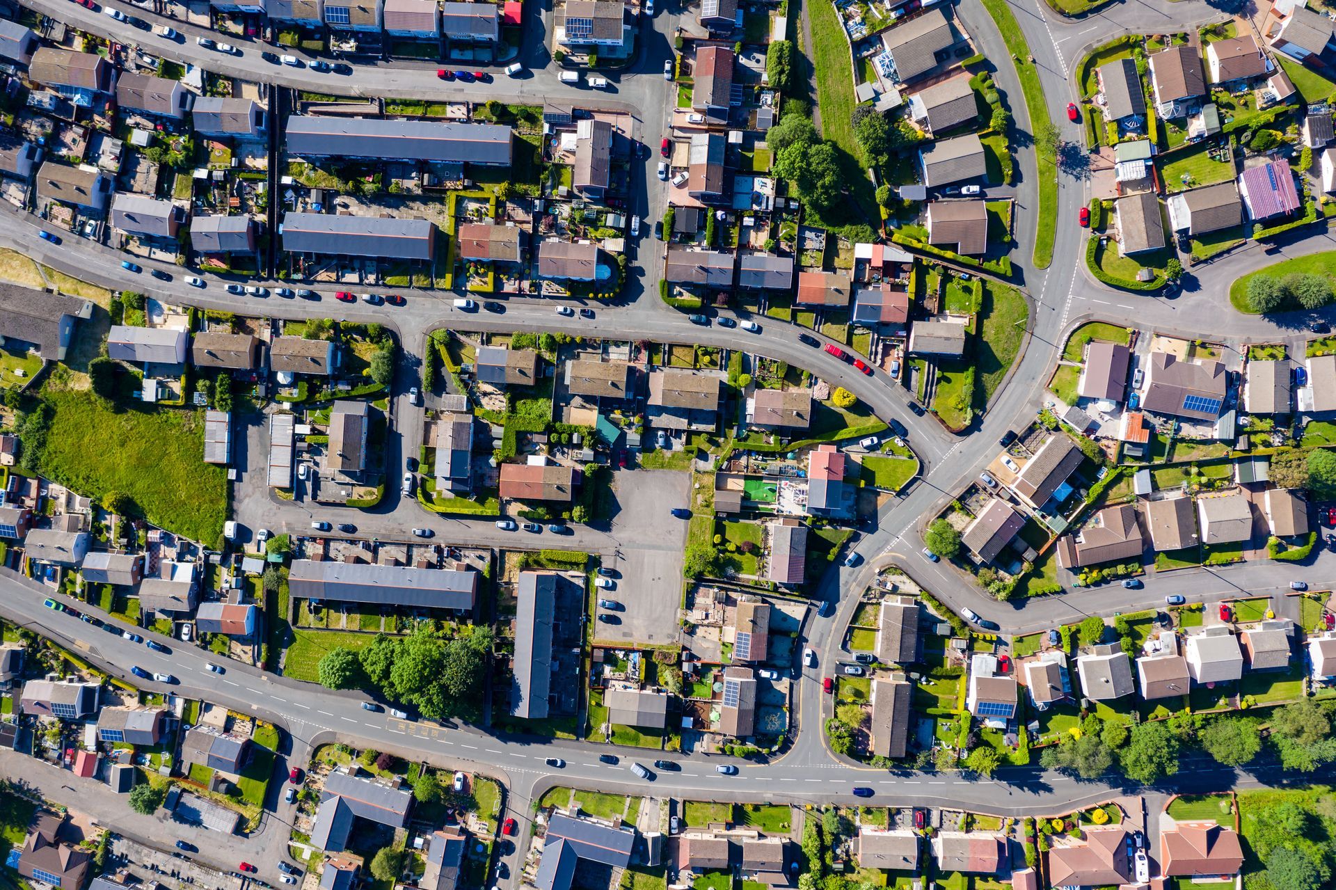 An aerial view of a residential area with lots of houses and roads.