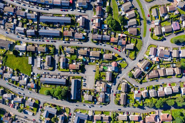 An aerial view of a residential area with lots of houses and roads.