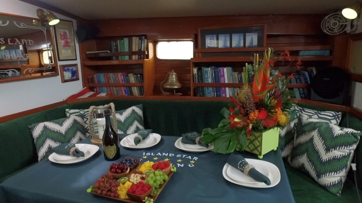 A table with plates and a bottle of wine on it