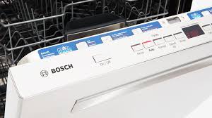 a close up of a bosch dishwasher with the door open .
