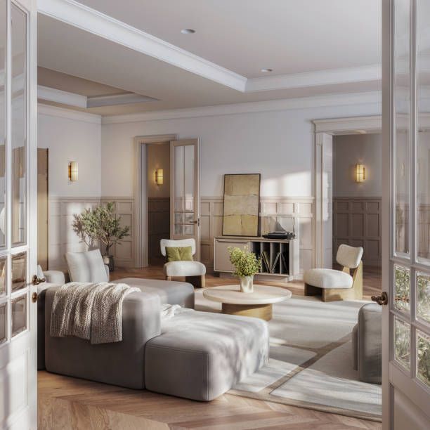 Living room with gray sofa, neutral chairs, and light wood floors. Sunlight streams through the open doors.