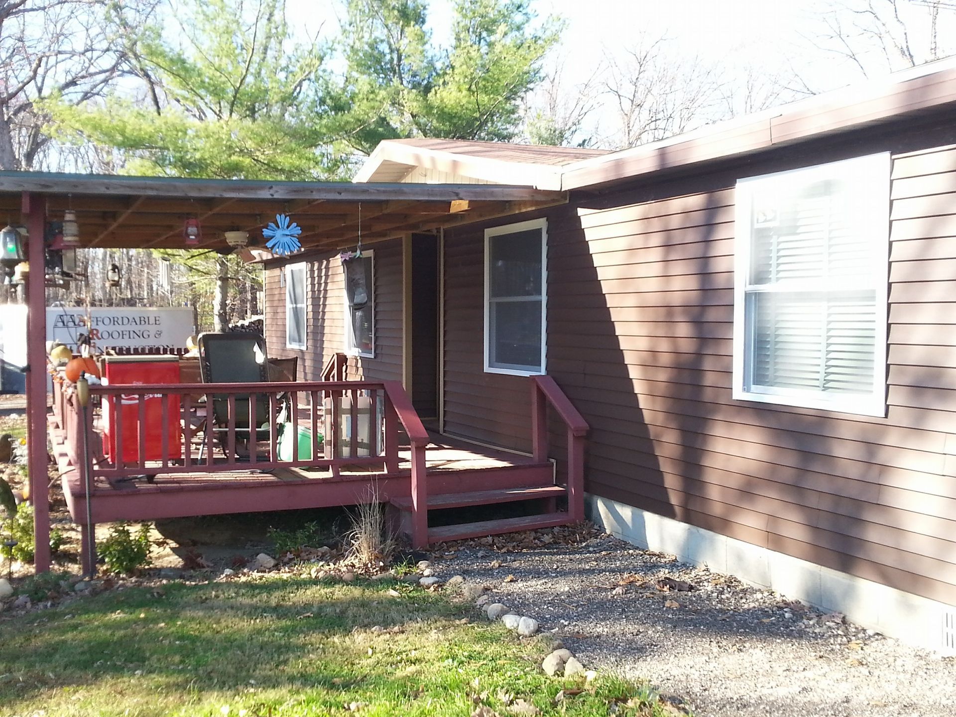 A house with a porch and a sign that says ' a ' on it