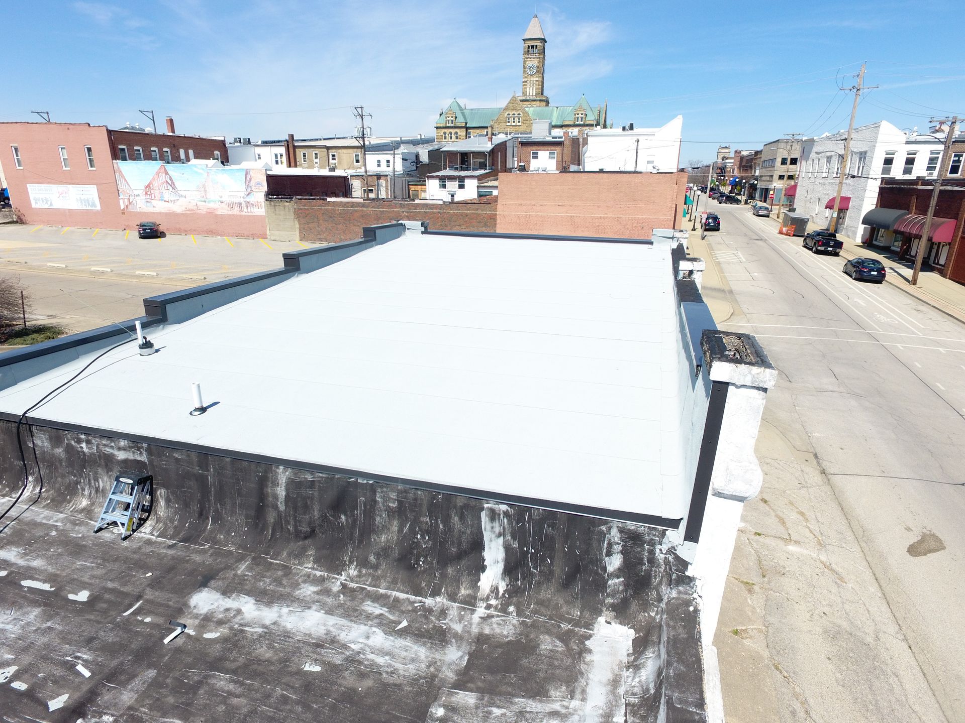 An aerial view of a building with a white roof.