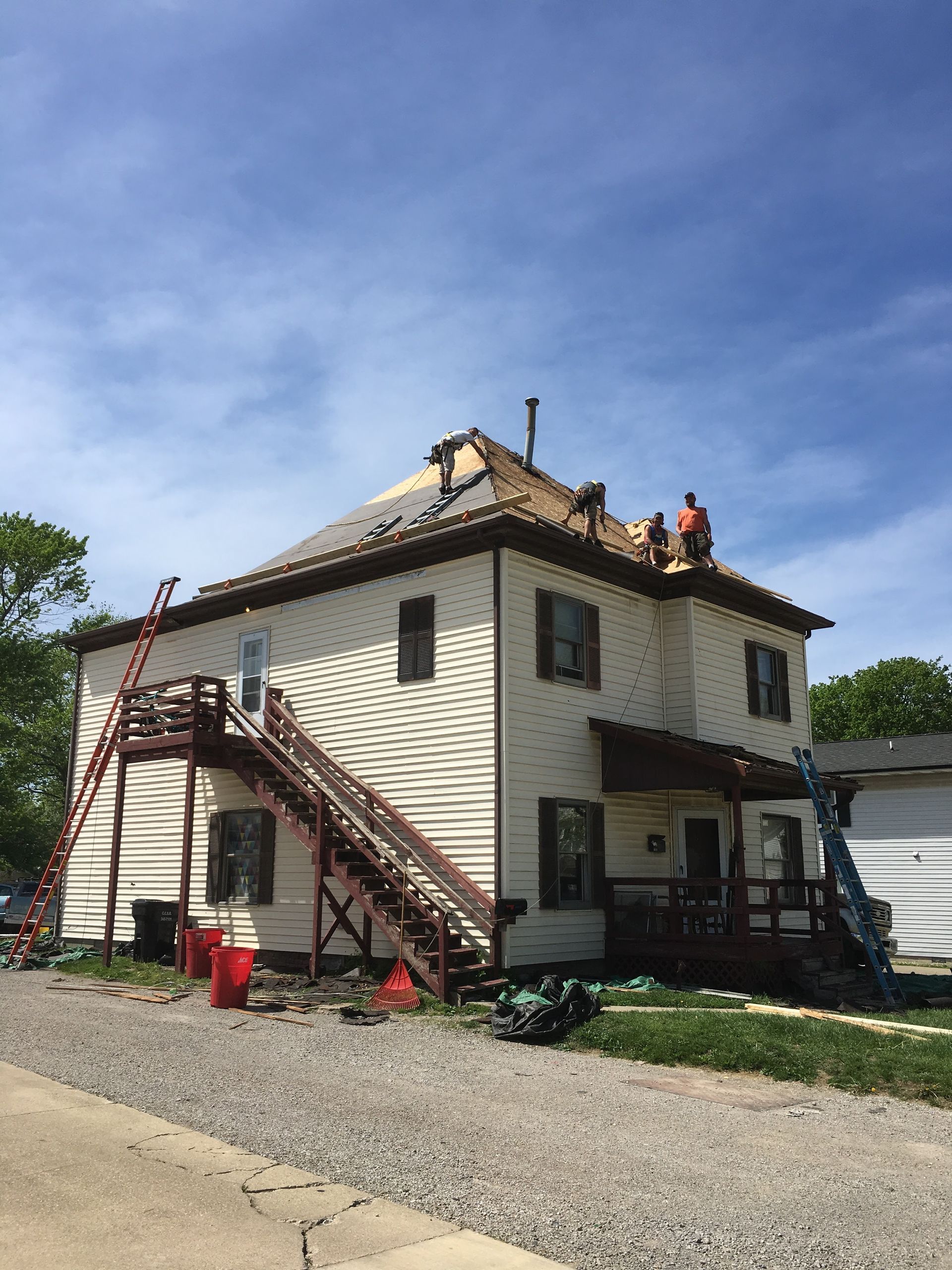 A house is being remodeled with a roof being installed.