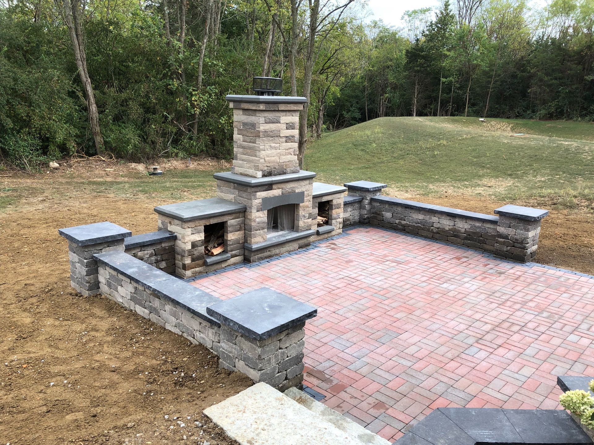 There is a fireplace in the middle of the patio.