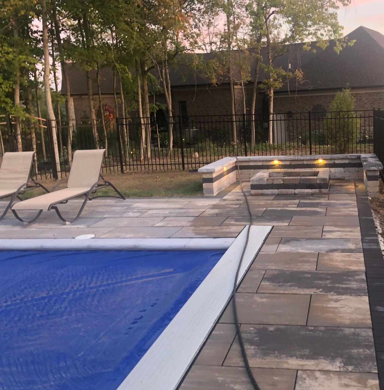 Swimming pool, sitting wall around fire pit.