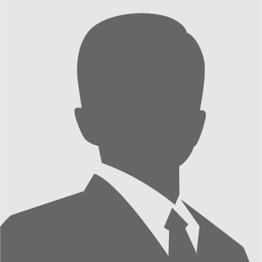 A placeholder silhouette icon of a person wearing a suit and tie against a plain light gray background.
