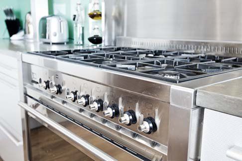 Stainless steel gas range in a modern kitchen.