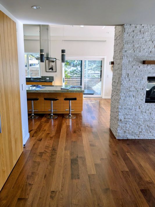 Staircase with black metal railing, gray steps, and white trim.