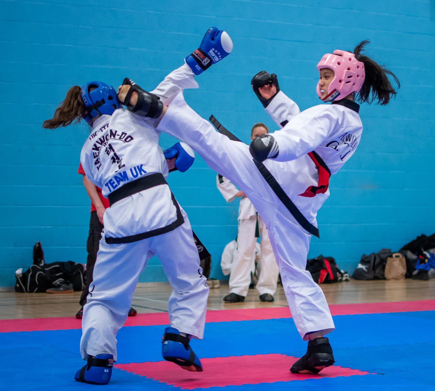 women sparring on mats