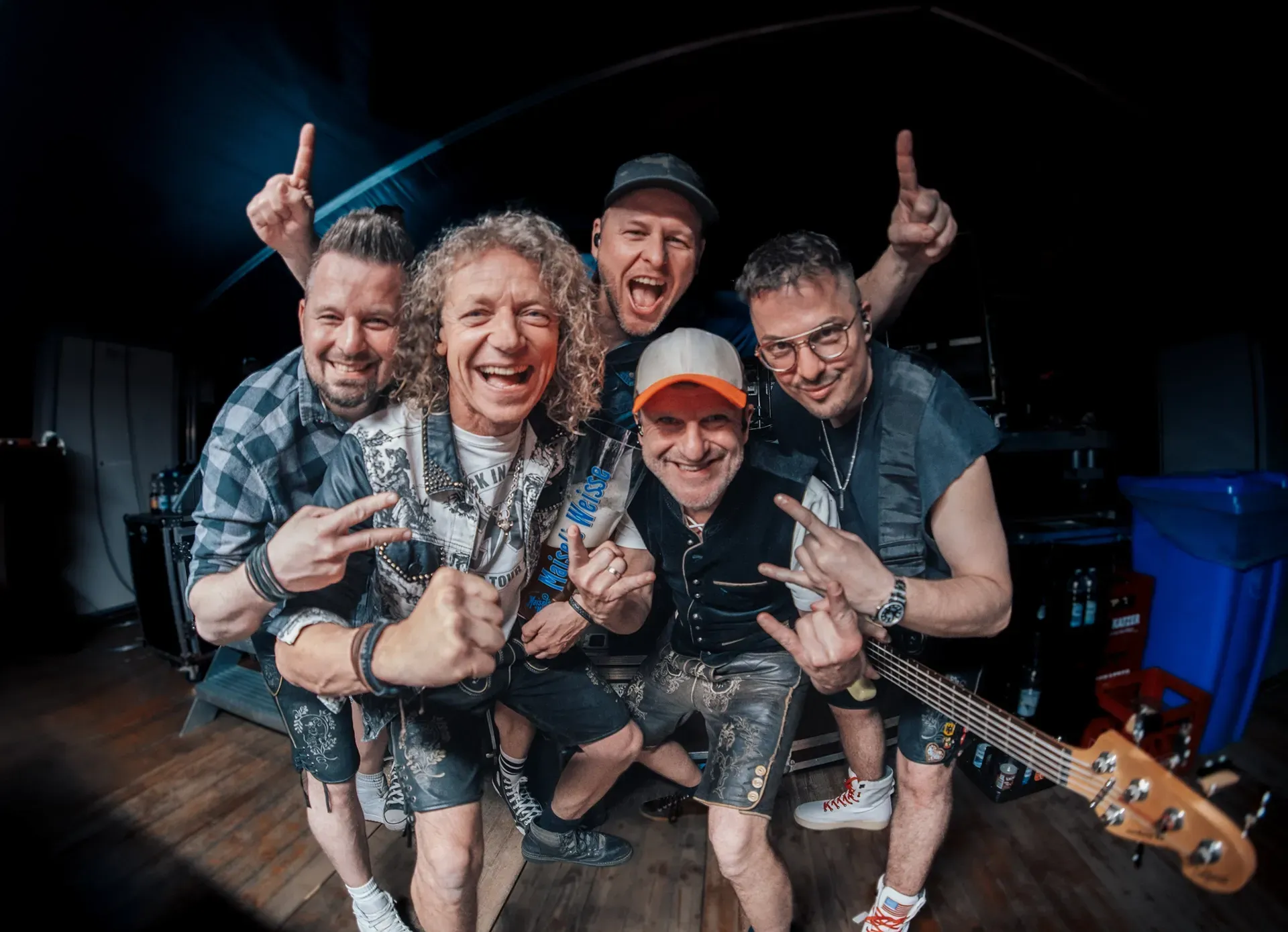 Die Band Troglauer posiert für ein Foto, während einer von ihnen eine Gitarre hält.