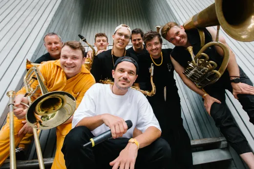 Eine Gruppe von Männern , die Blechblasinstrumente spielen, posiert für ein Foto.