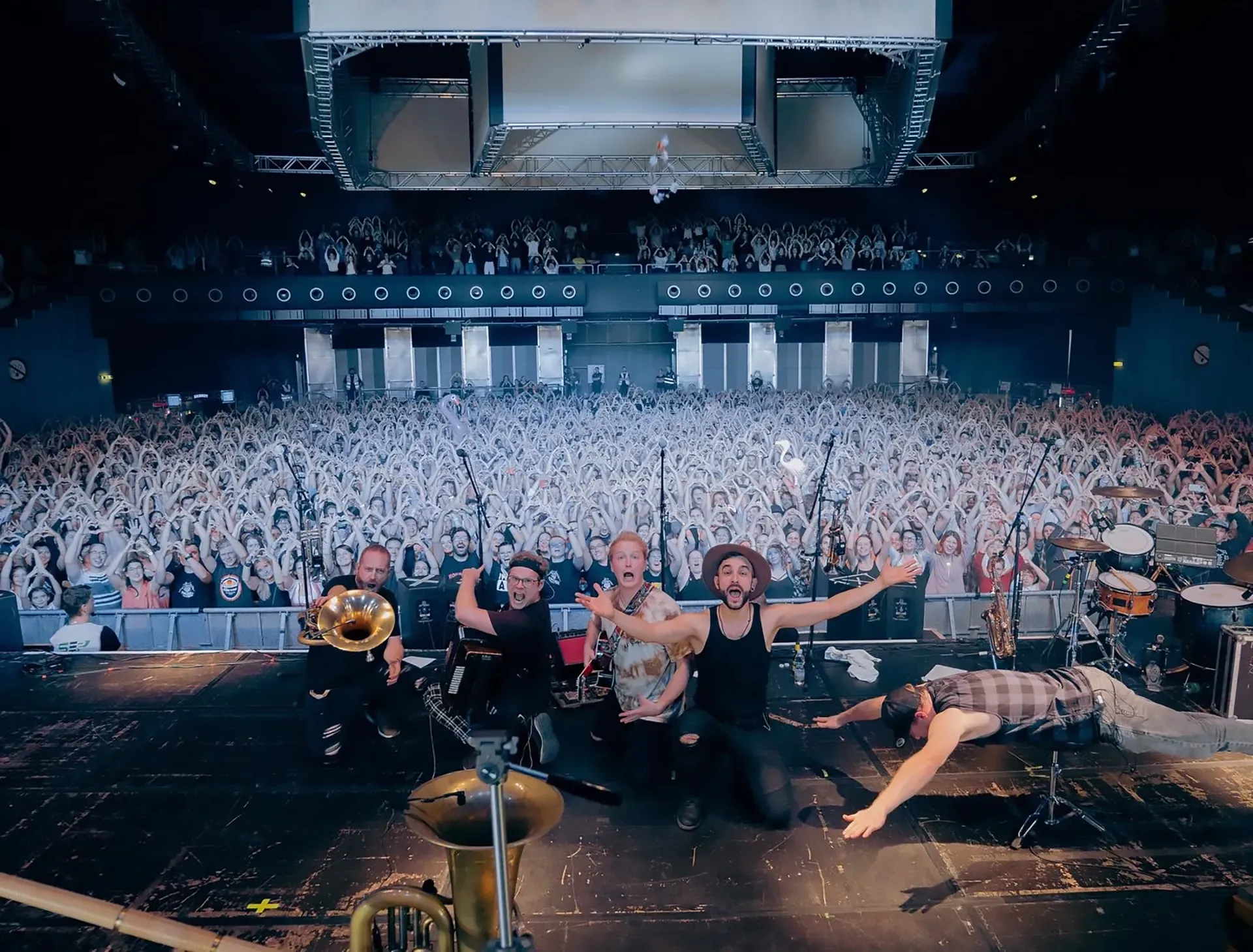 Eine Gruppe von Menschen, die vor einer Menschenmenge auf einer Bühne stehen