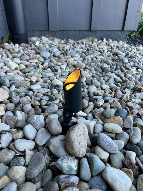 A black light is sitting on top of a pile of rocks.