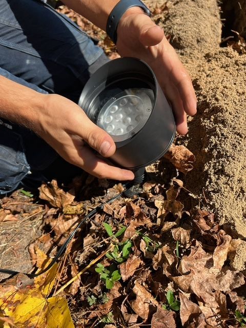 A person is holding a black object in their hands