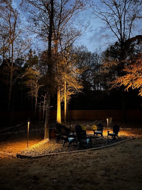 A wooden walkway with lights on the side of it at night.