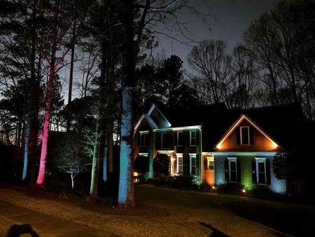 A house is lit up with colorful lights at night